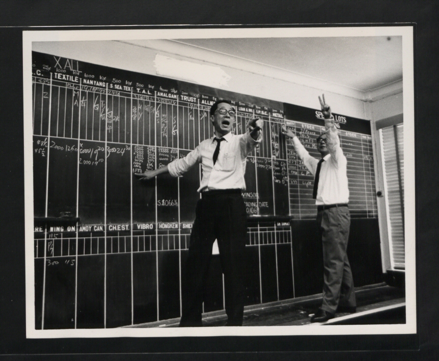 Brokers working amid phones and papers on the Hong Kong stock exchange in 1969.